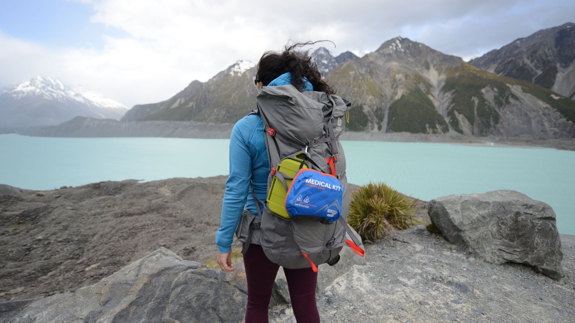 Woman backpacker in front of water