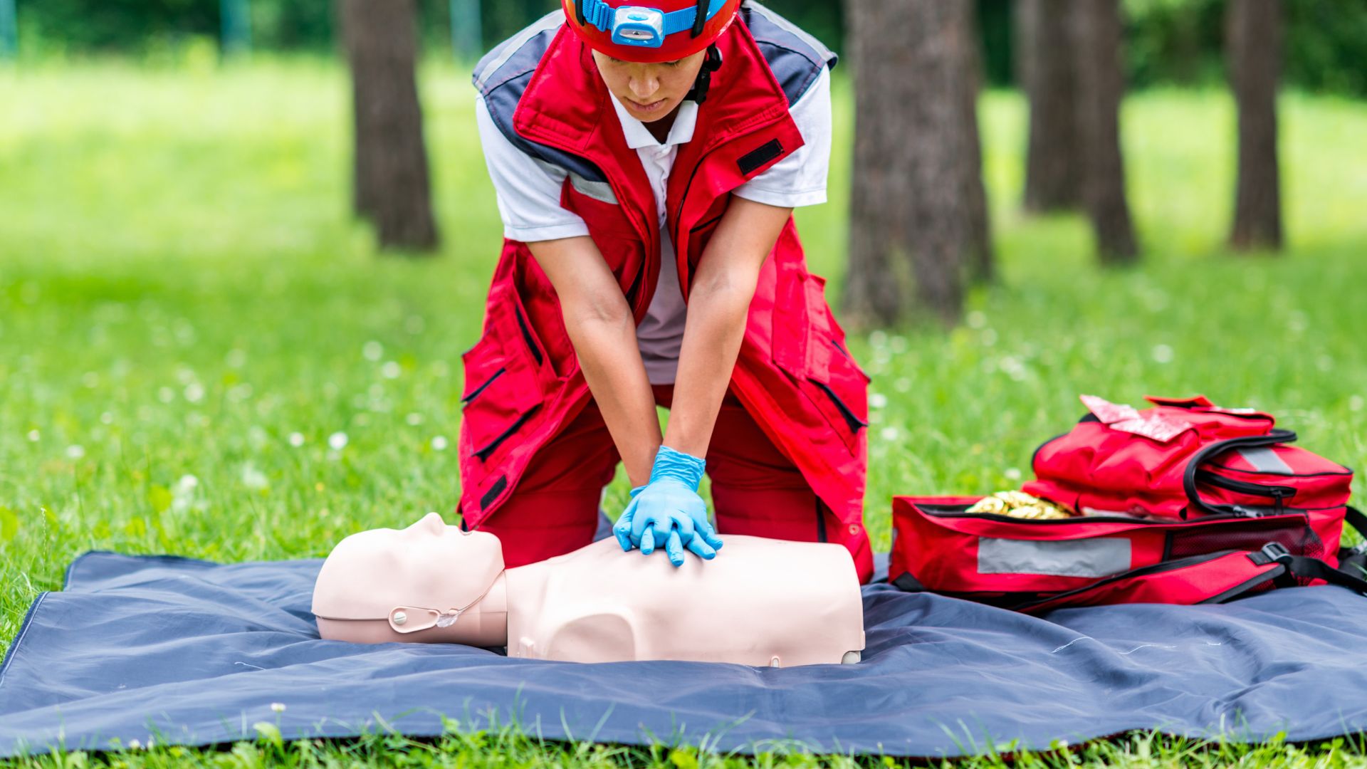Person giving CPR to a dummy outside