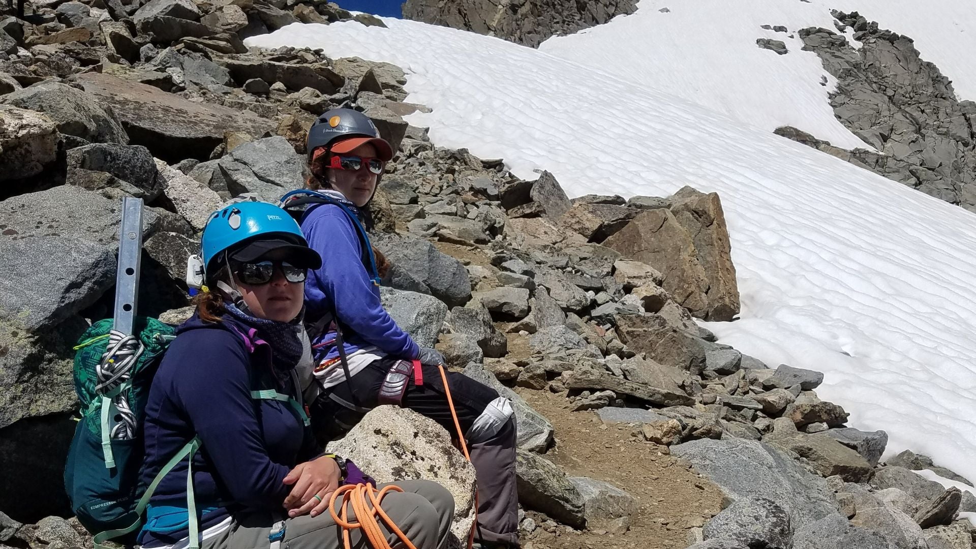 Two people mountaineering taking a rest