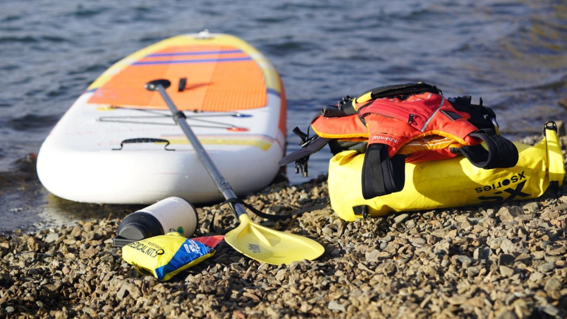 Paddling gear next to paddleboard