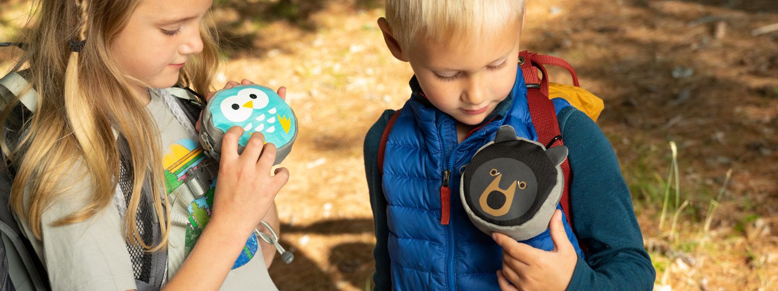 Two children inspecting their Backyard Adventure Kits