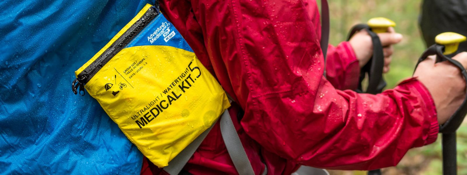 Person with Ultralight Watertight Kit on backpack in rain