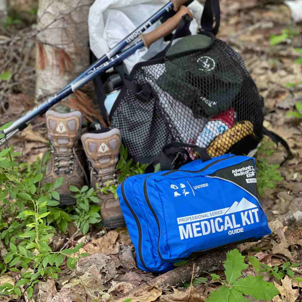 Pro Series Emergency Medical Kit - Guide I kit posed next to hiking gear