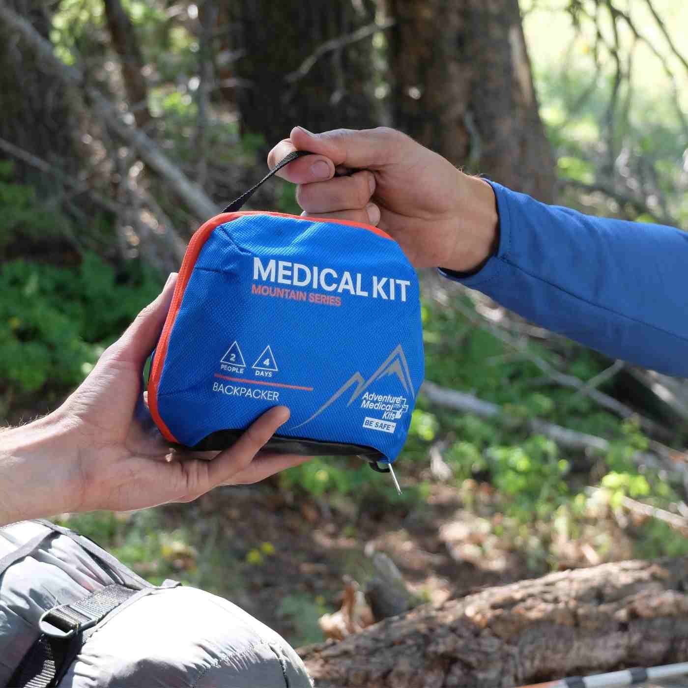 Mountain Series Medical Kit - Backpacker passing to a friend