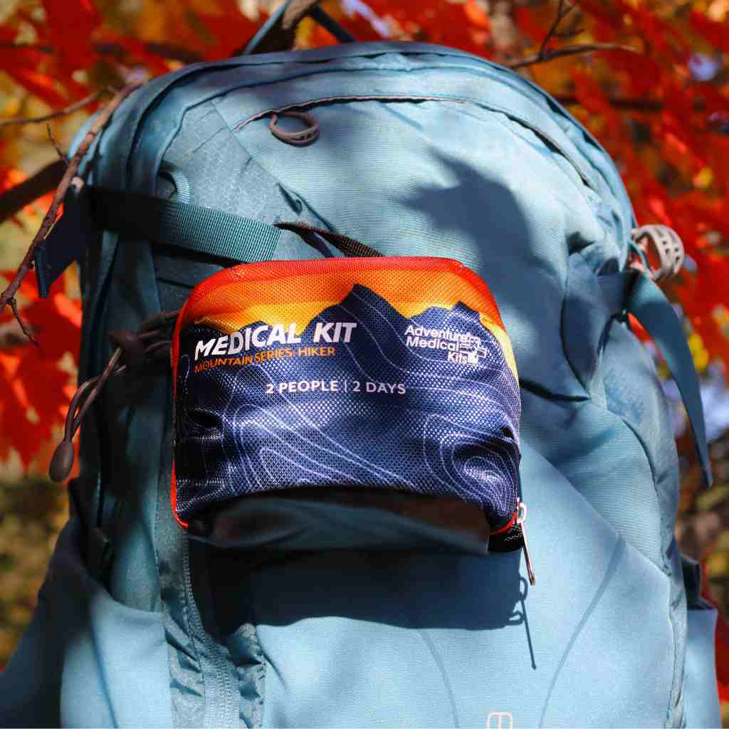 Mountain Series Hiker Sunset Kit on blue backpack in front of fall leaves