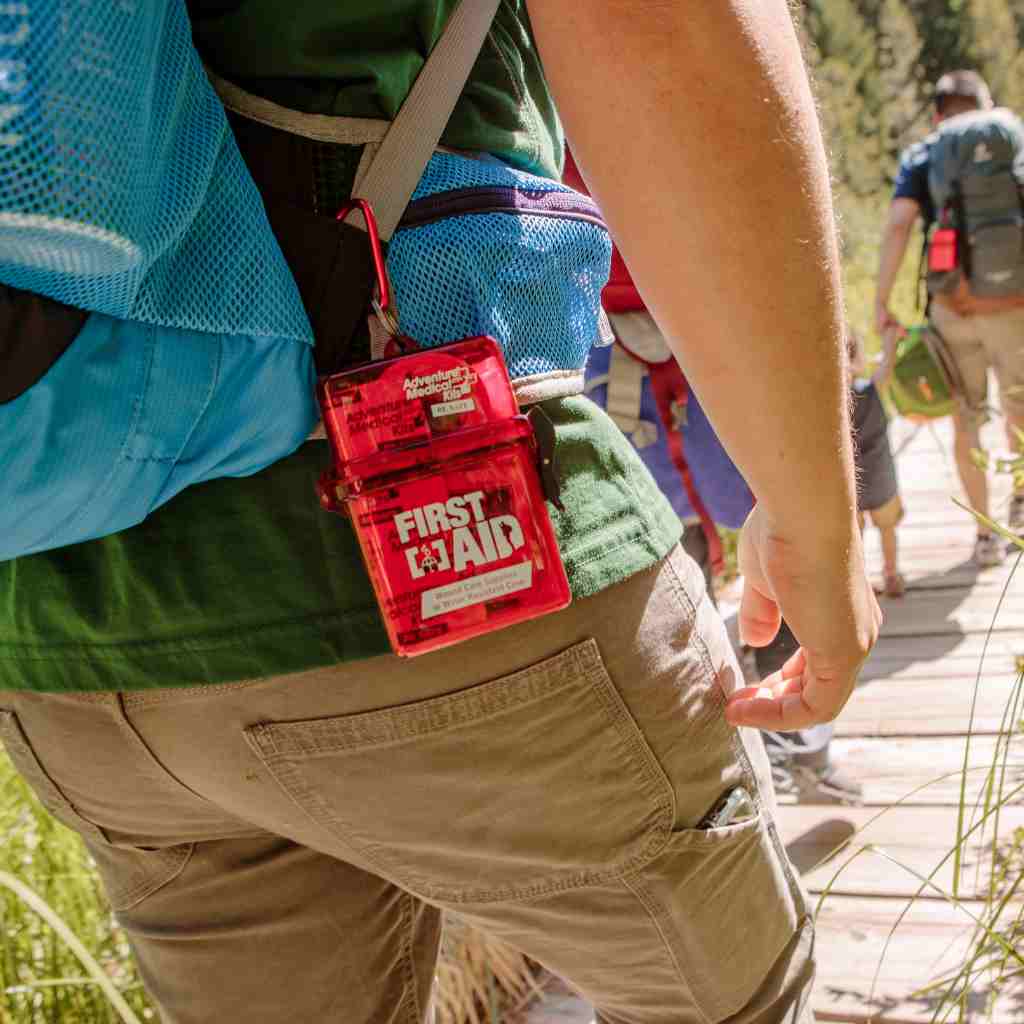 Adventure First Aid, Water-Resistant Kit kit attached to person's kit while hiking