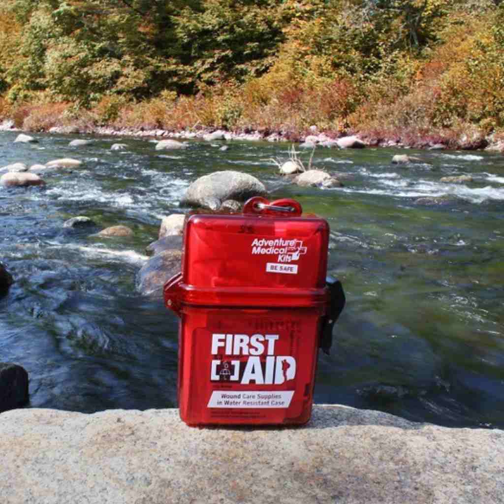 Adventure First Aid, Water-Resistant Kit kit on rock in front of river