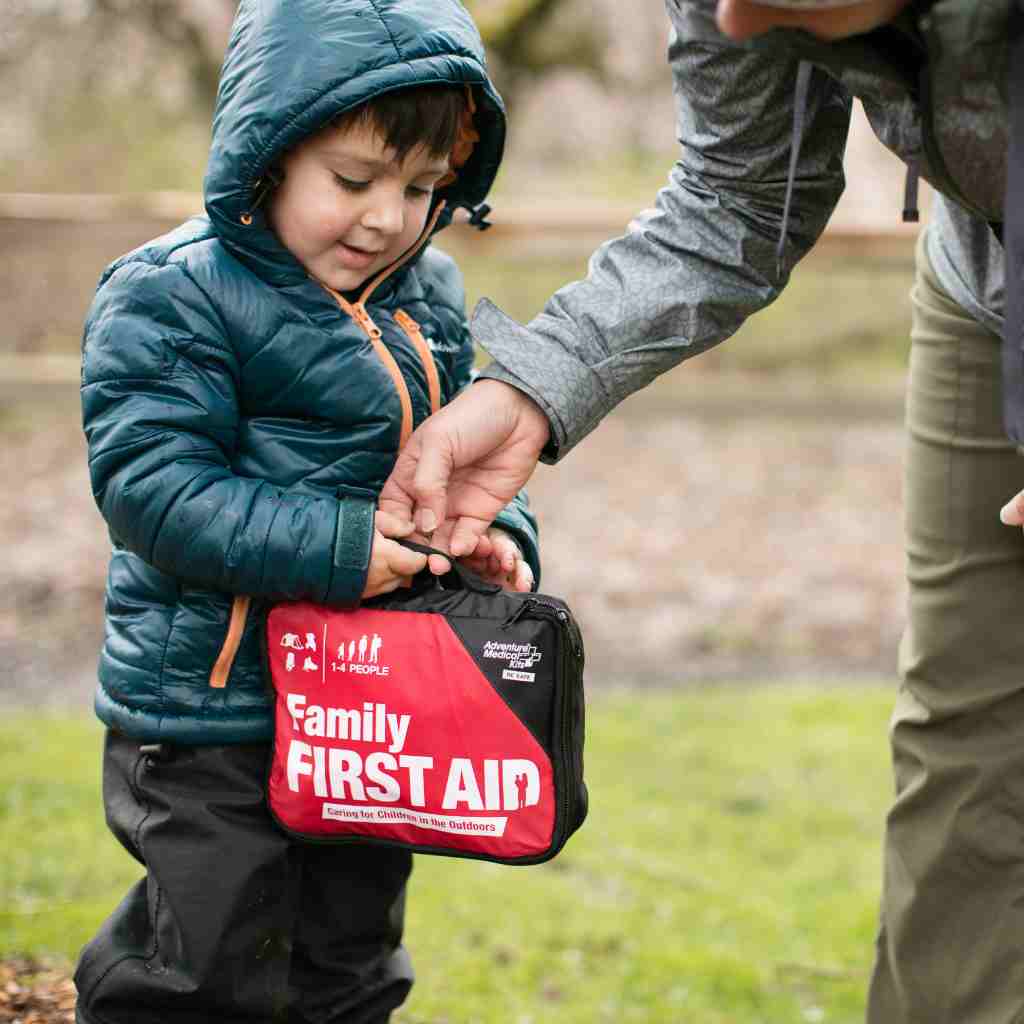 Adventure First Aid, Family First Aid Kit person and child holding kit outside