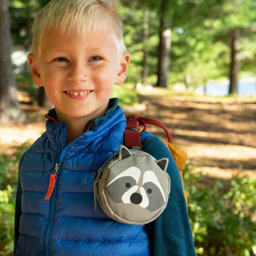 Backyard Adventure Raccoon First Aid Kit kit on front of child's backpack