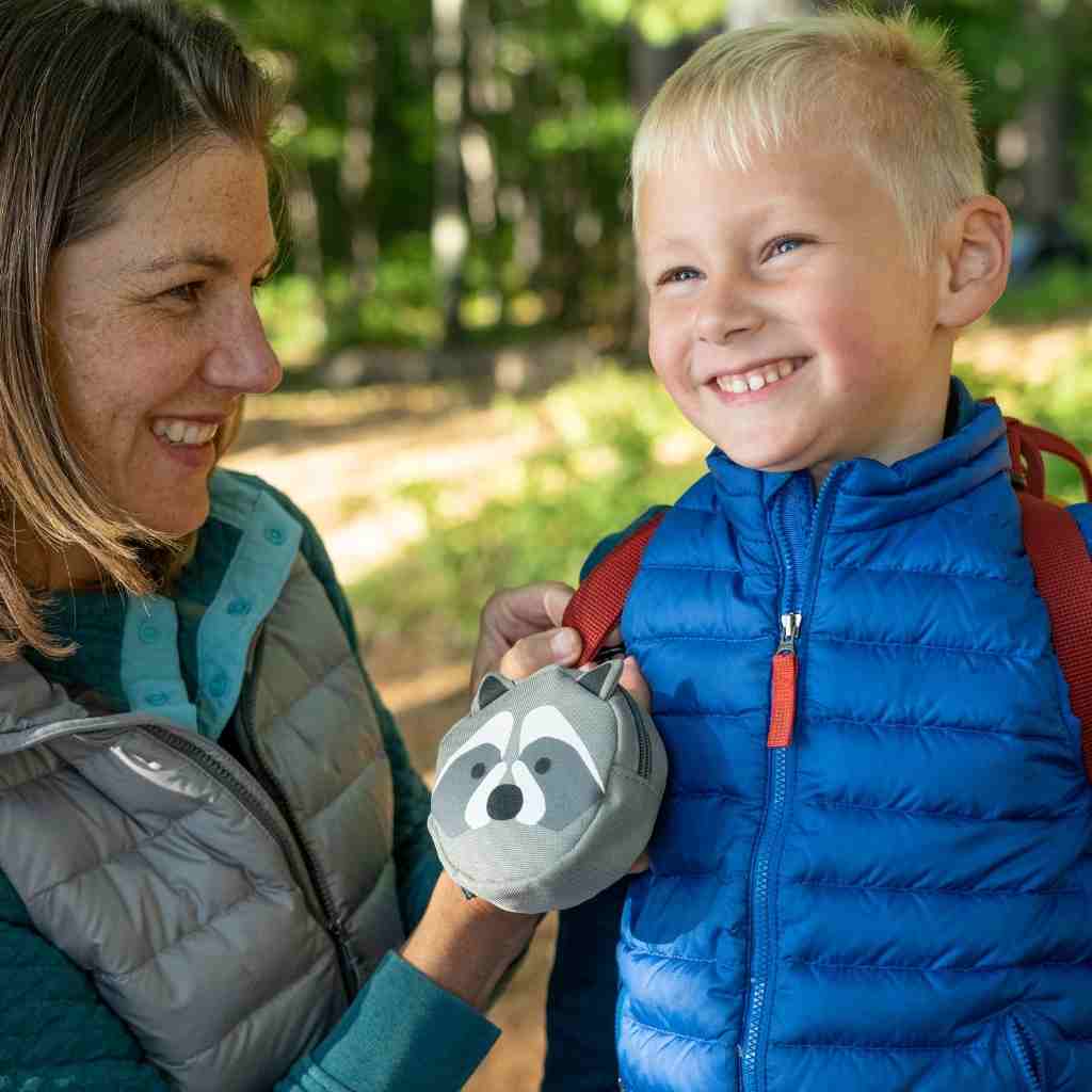 Backyard Adventure Raccoon First Aid Kit mother attaching kit to child's backpack
