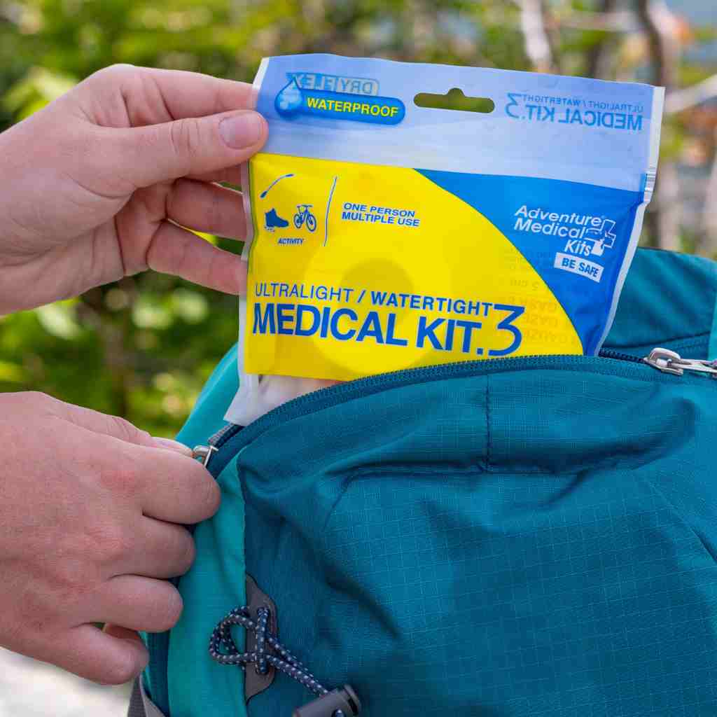 Ultralight/Watertight Medical Kit - .3 removing kit from blue backpack