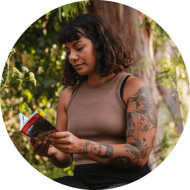 Woman reading Wilderness First Aid Guide