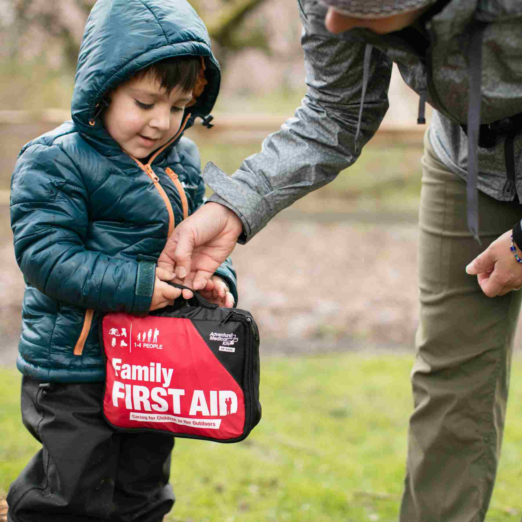 Adventure First Aid, Family First Aid Kit person and child holding kit outside