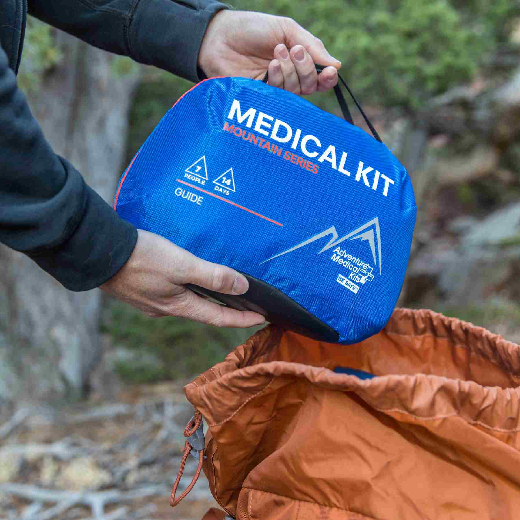Mountain Series Medical Kit - Guide pulling from orange backpack