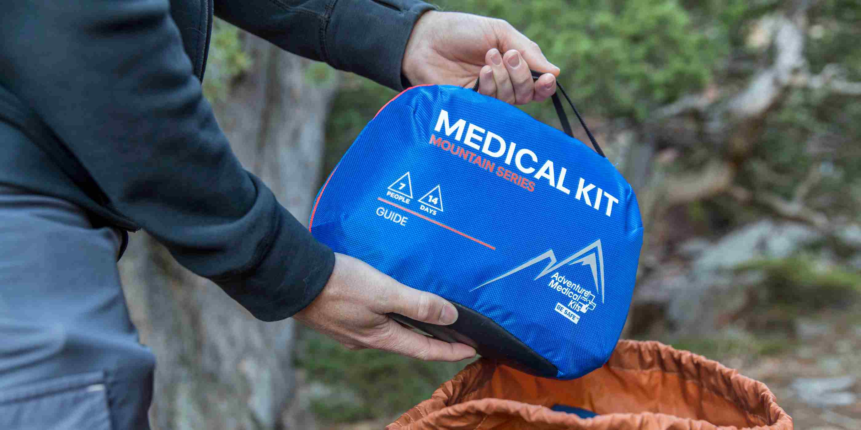 Mountain Series Medical Kit - Guide pulling from orange backpack