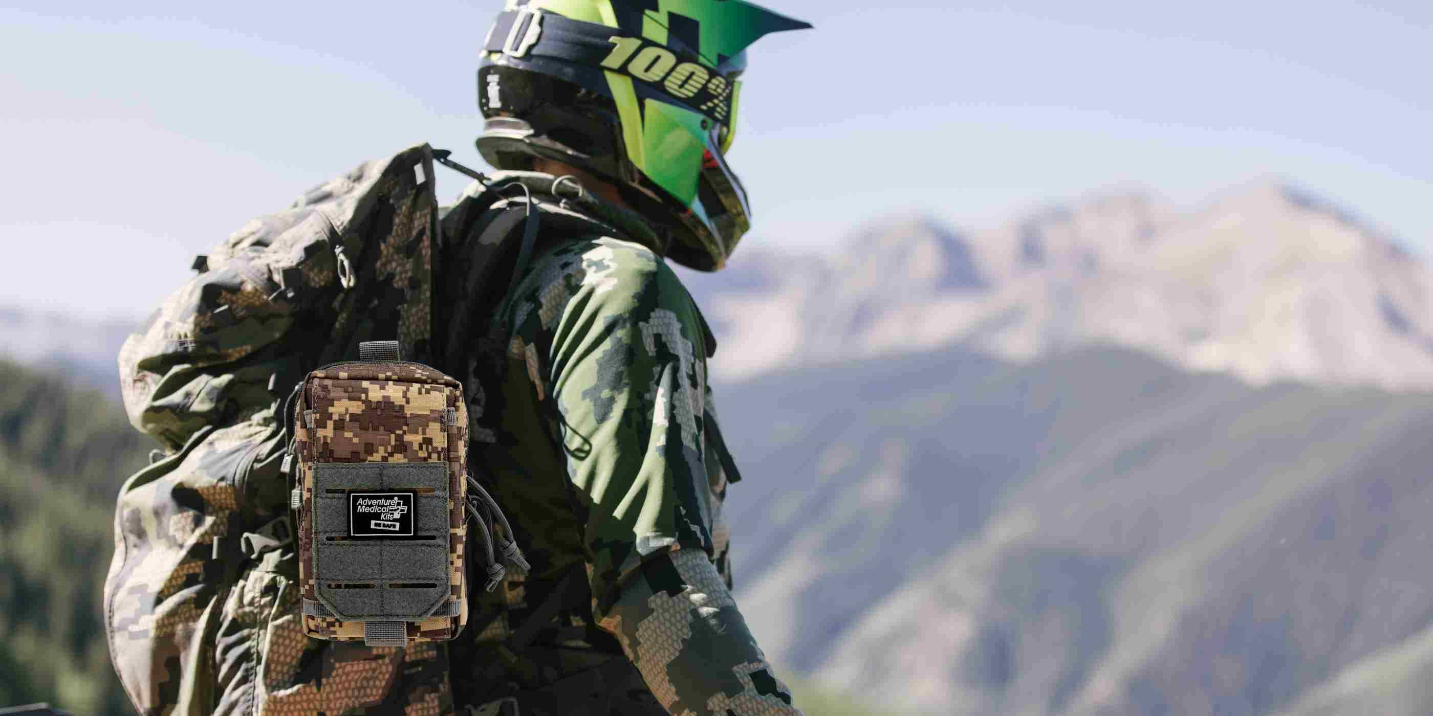MOLLE Bag Trauma Kit 0.5 - Camo man in helmet wearing kit on backpack
