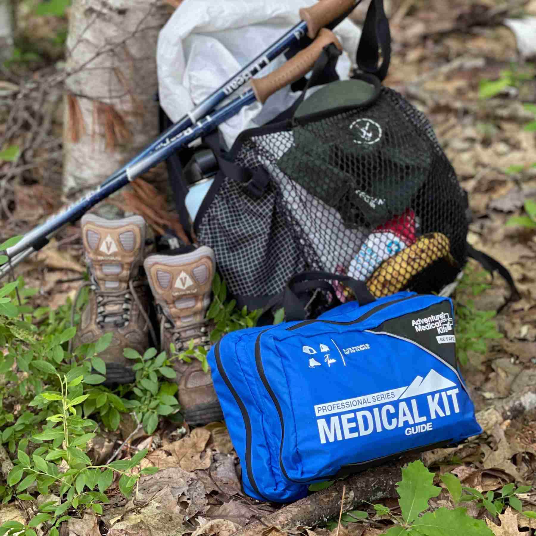 Pro Series Emergency Medical Kit - Guide I kit posed next to hiking gear