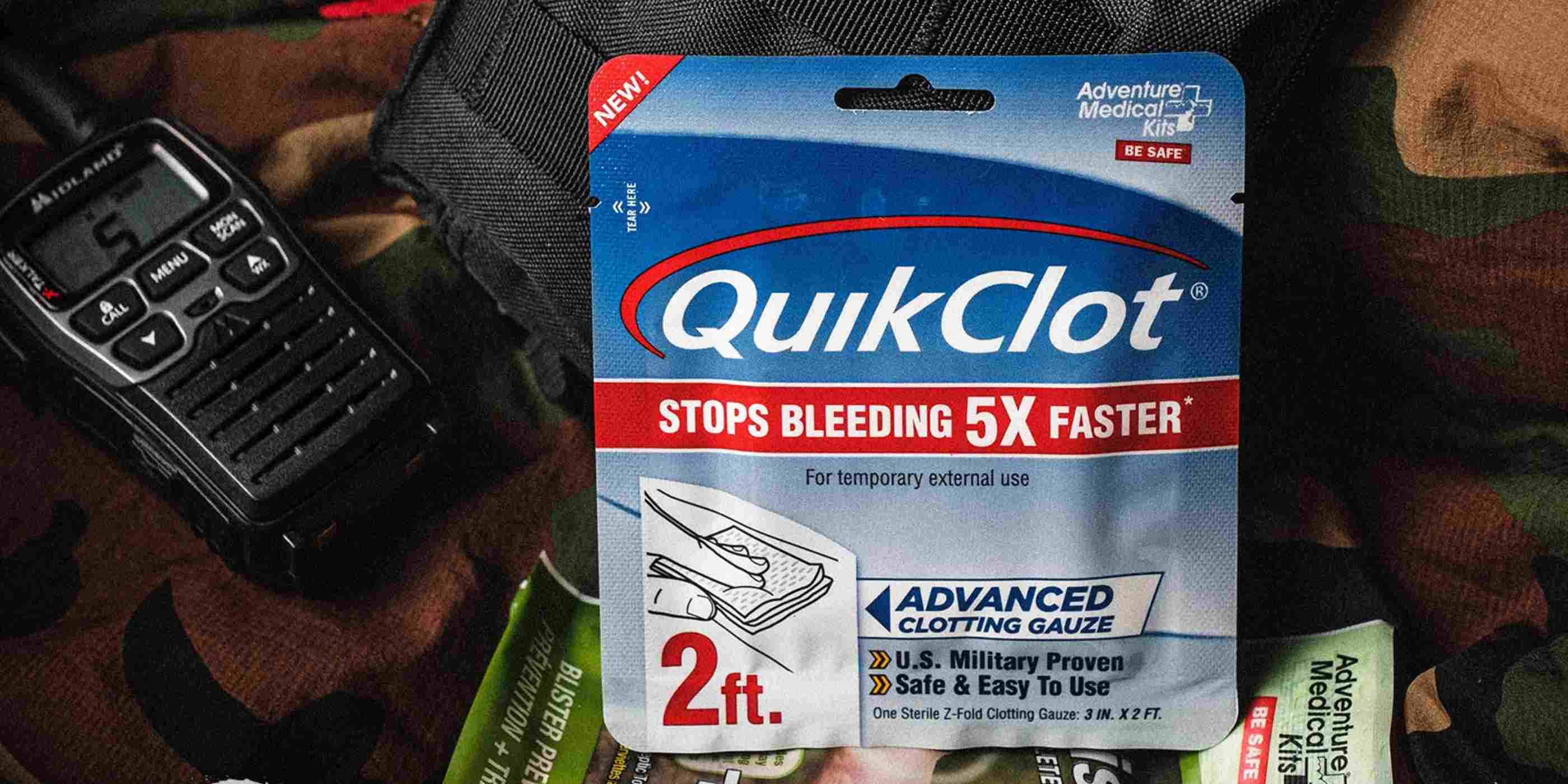 QuikClot Gauze 2 Foot posed in front of kit with First Aid patch