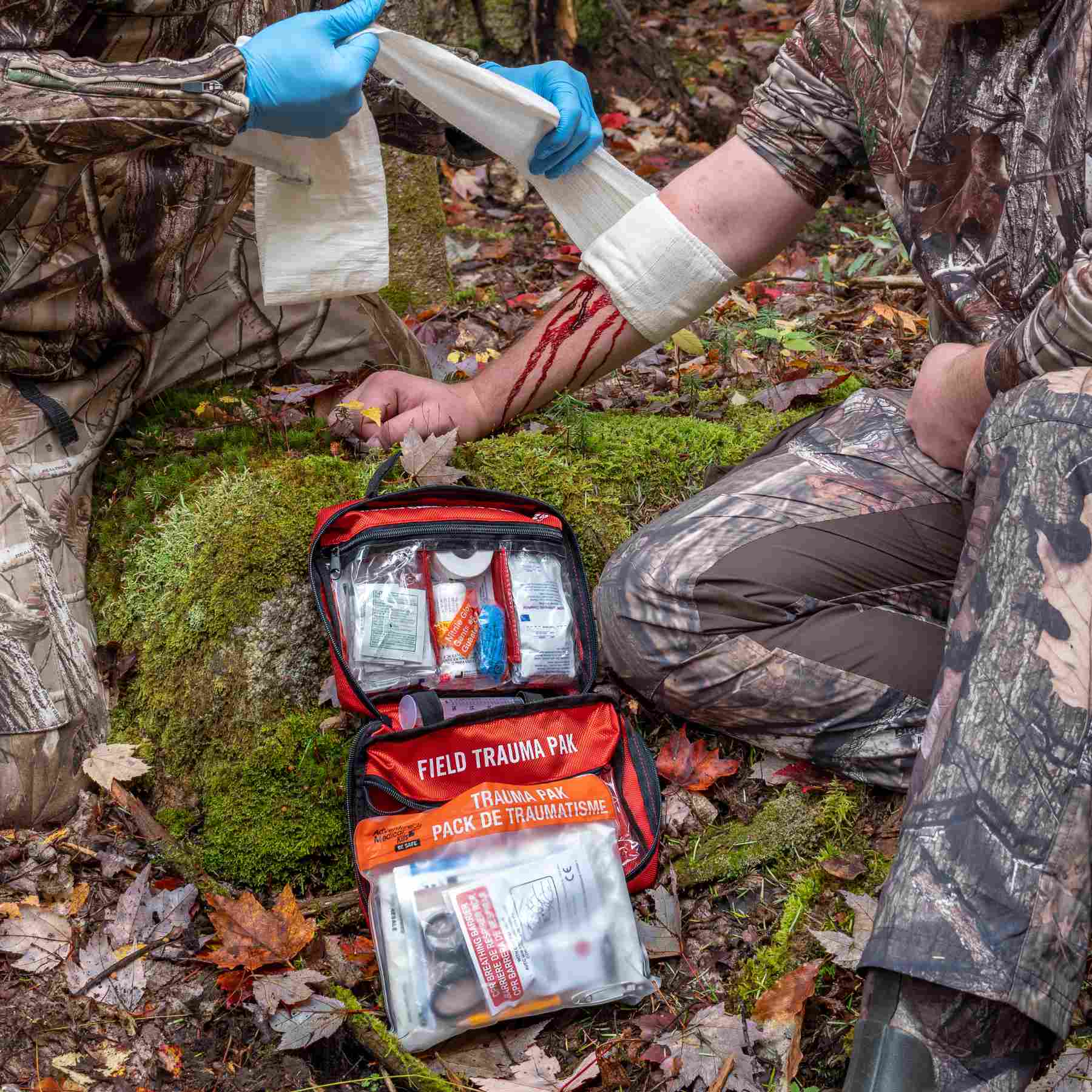 Sportsman Series Medical Kit - 400 man applying gauze to friend's arm with kit in background