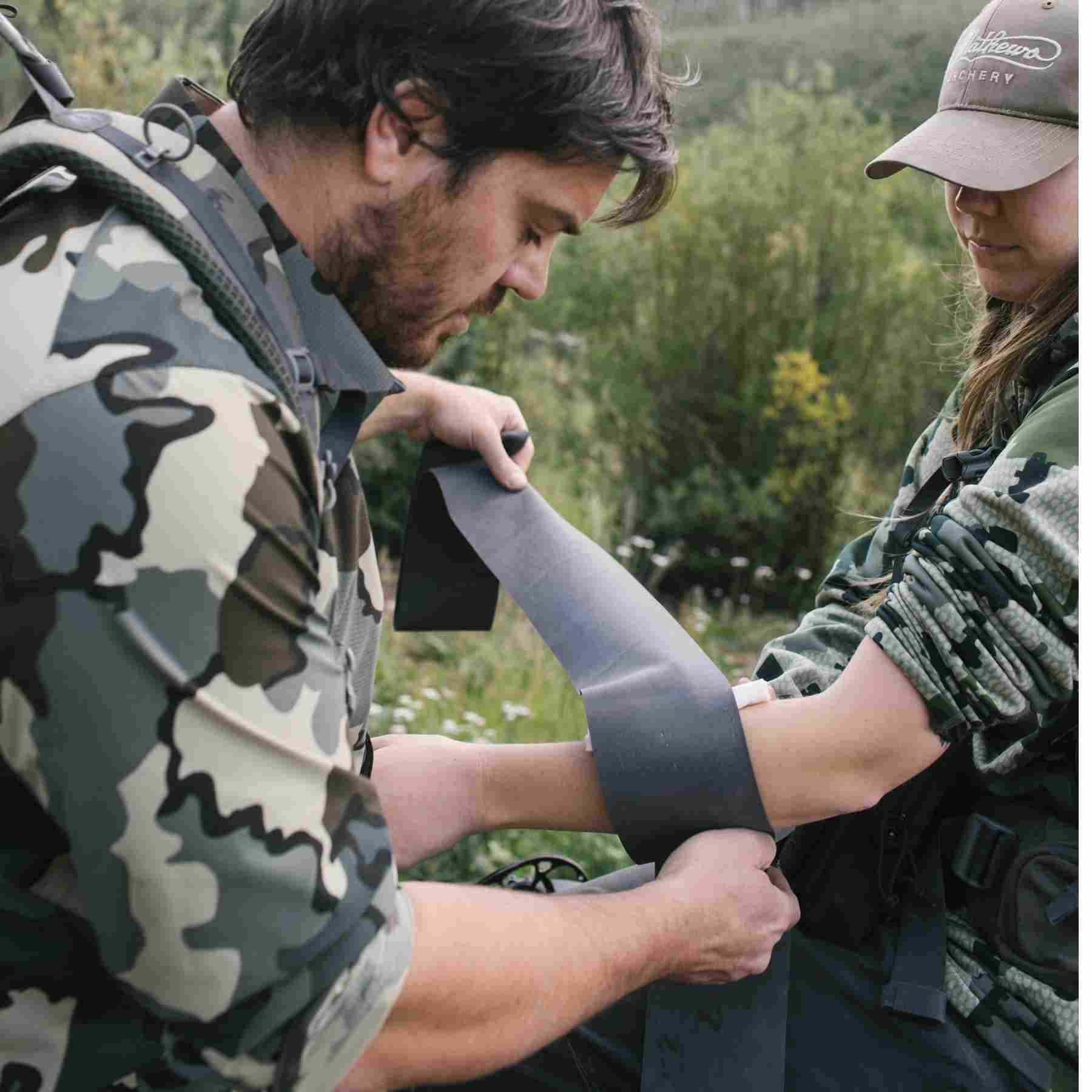 Trauma Pak Pro with QuikClot & Trauma Tourniquet man using tourniquet on friend