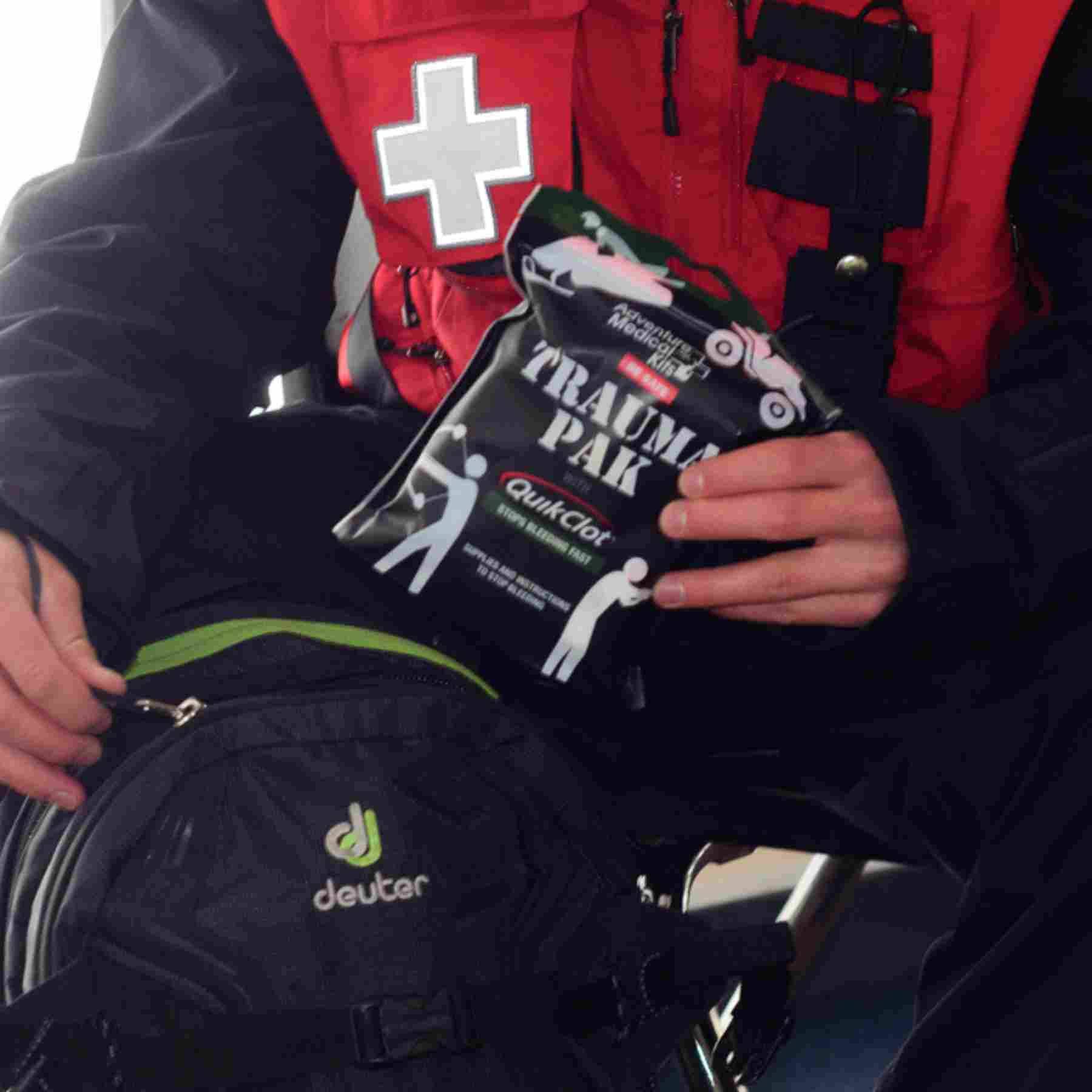 Trauma Pak First Aid Kit with QuikClot Ski Patrol removing kit from backpack