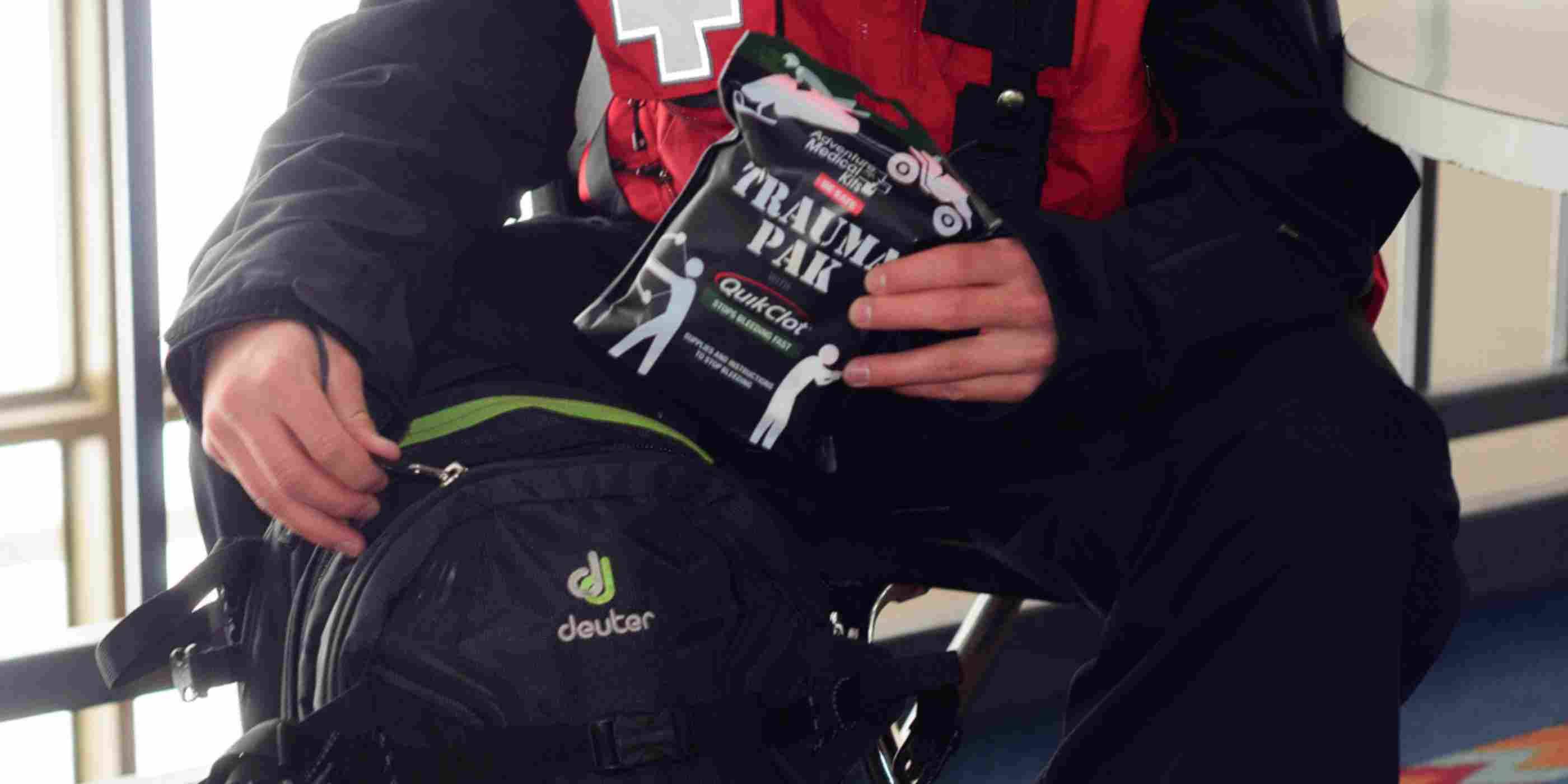 Trauma Pak First Aid Kit with QuikClot Ski Patrol removing kit from backpack