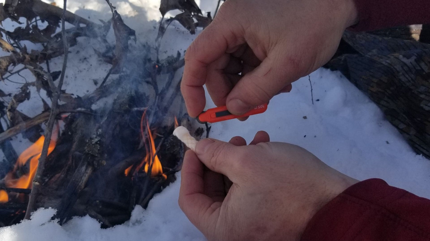 Building a fire in snow