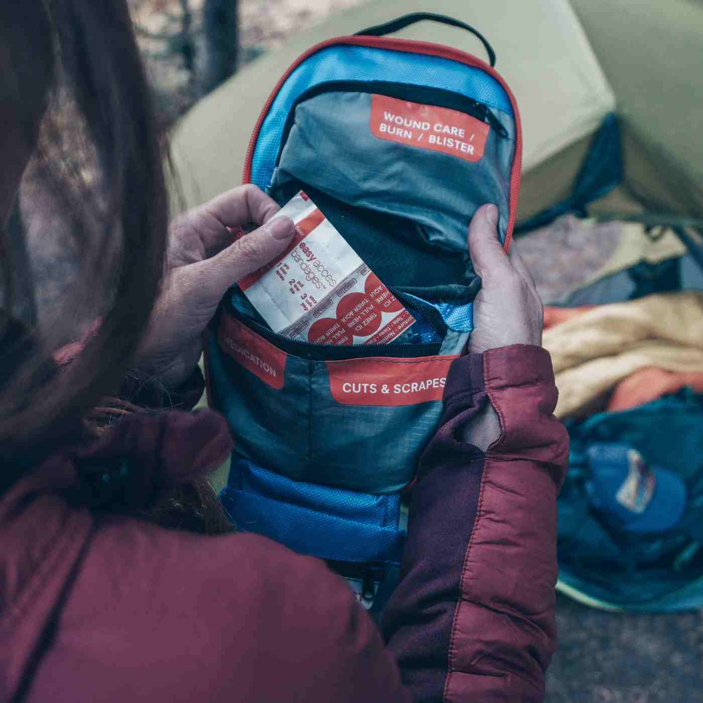 Mountain Series Medical Kit - Hiker woman removing bandages from kit