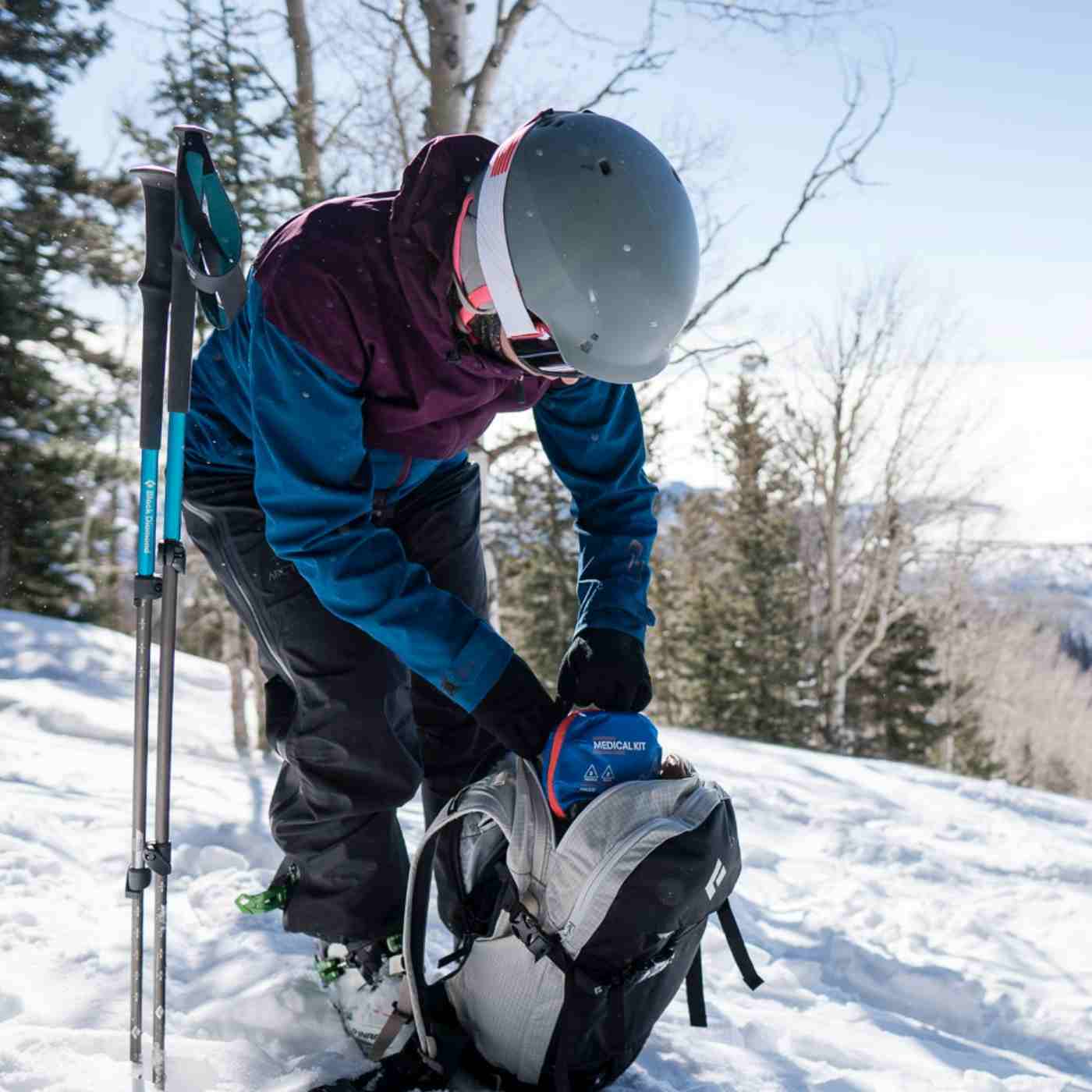 Mountain Series Medical Kit - Hiker skier removing kit from backpack