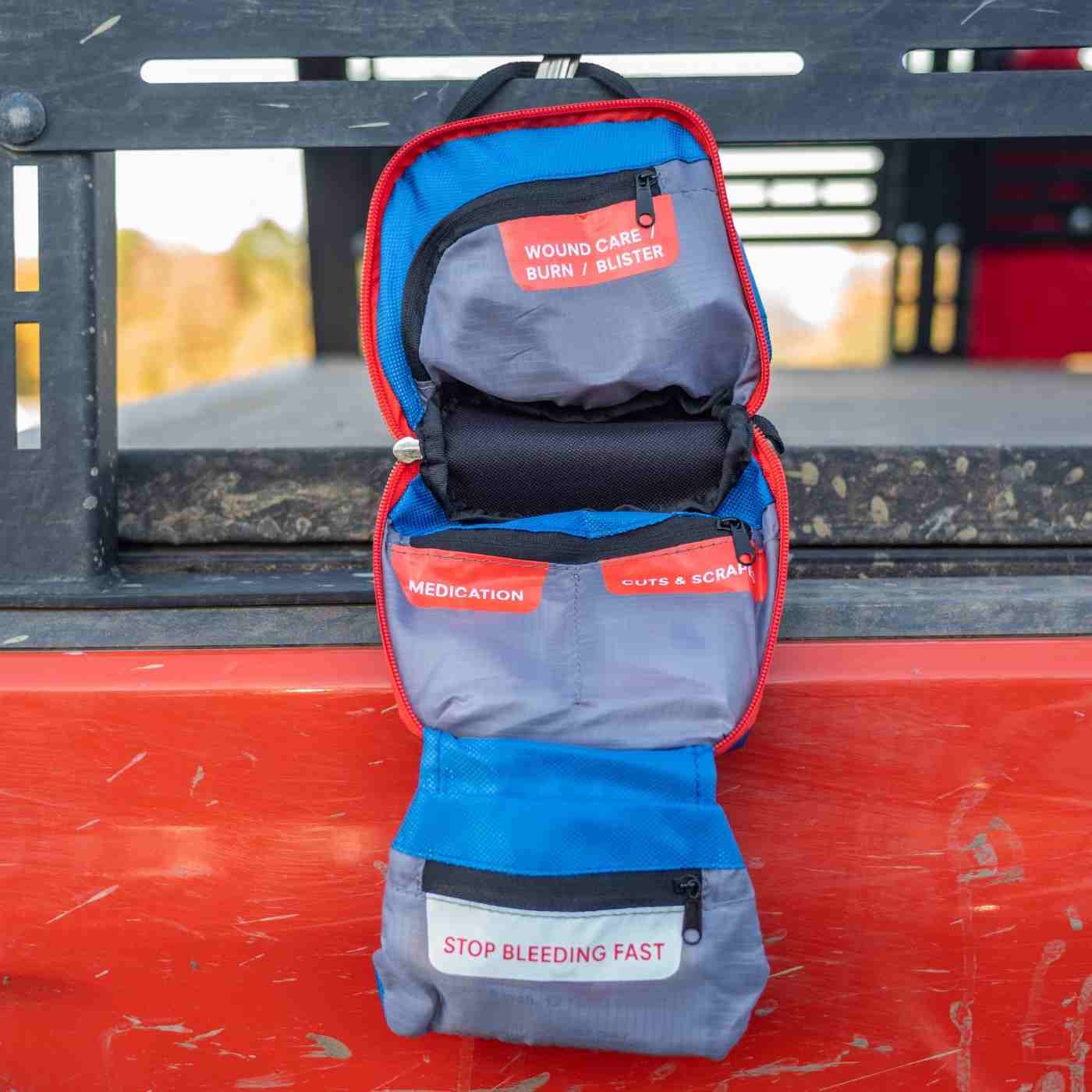 Mountain Series Medical Kit - Hiker kit opened hanging on red truck
