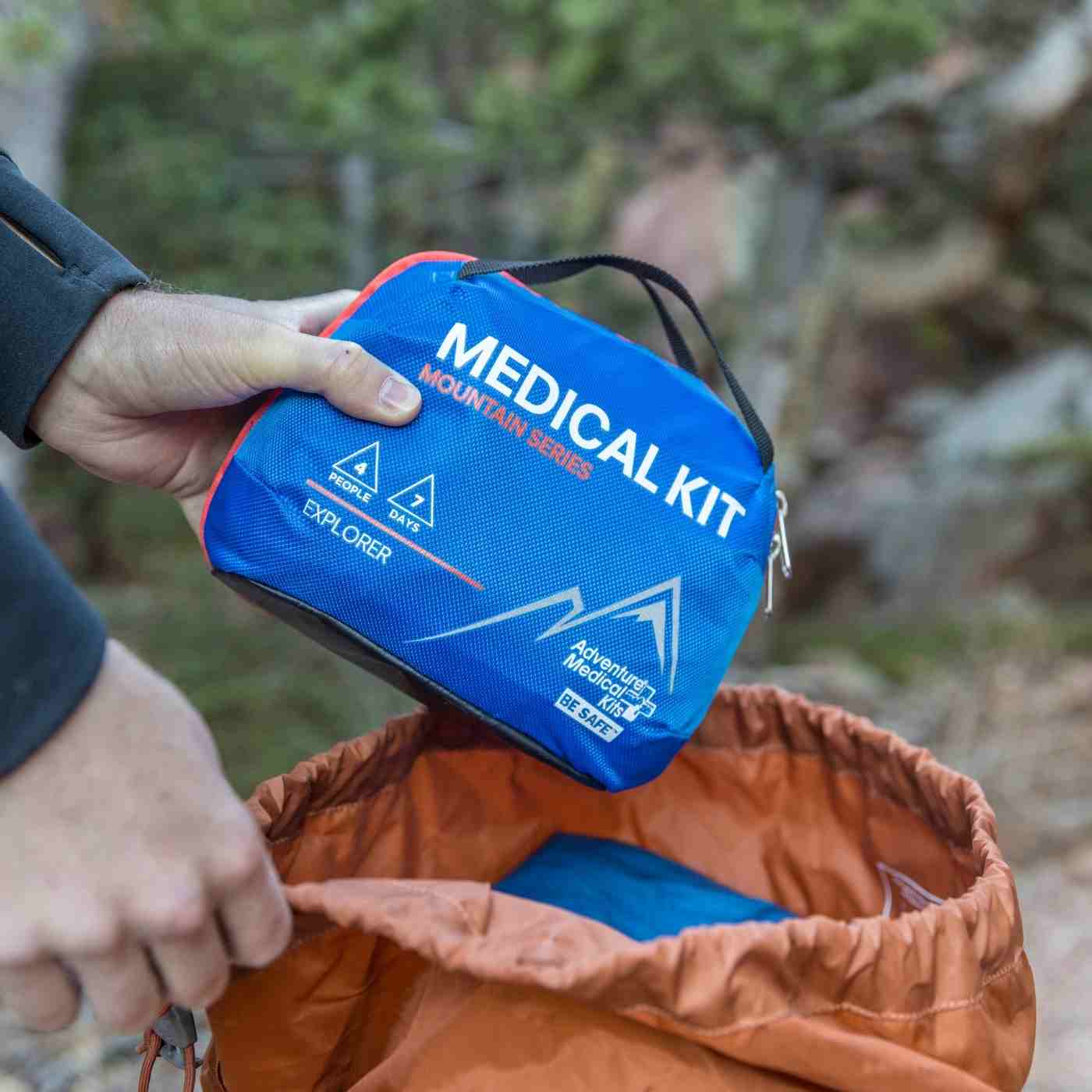 Mountain Series Medical Kit - Explorer pulling kit from orange backpack