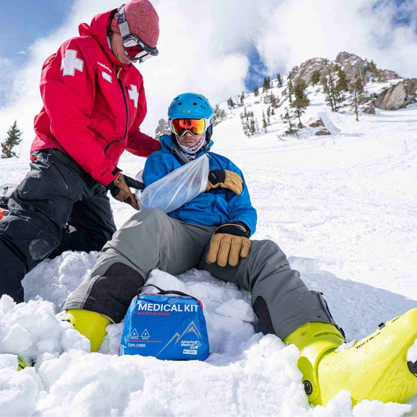 Mountain Series Medical Kit - Explorer Ski Patrol tending to broken arm with kit in front on snow
