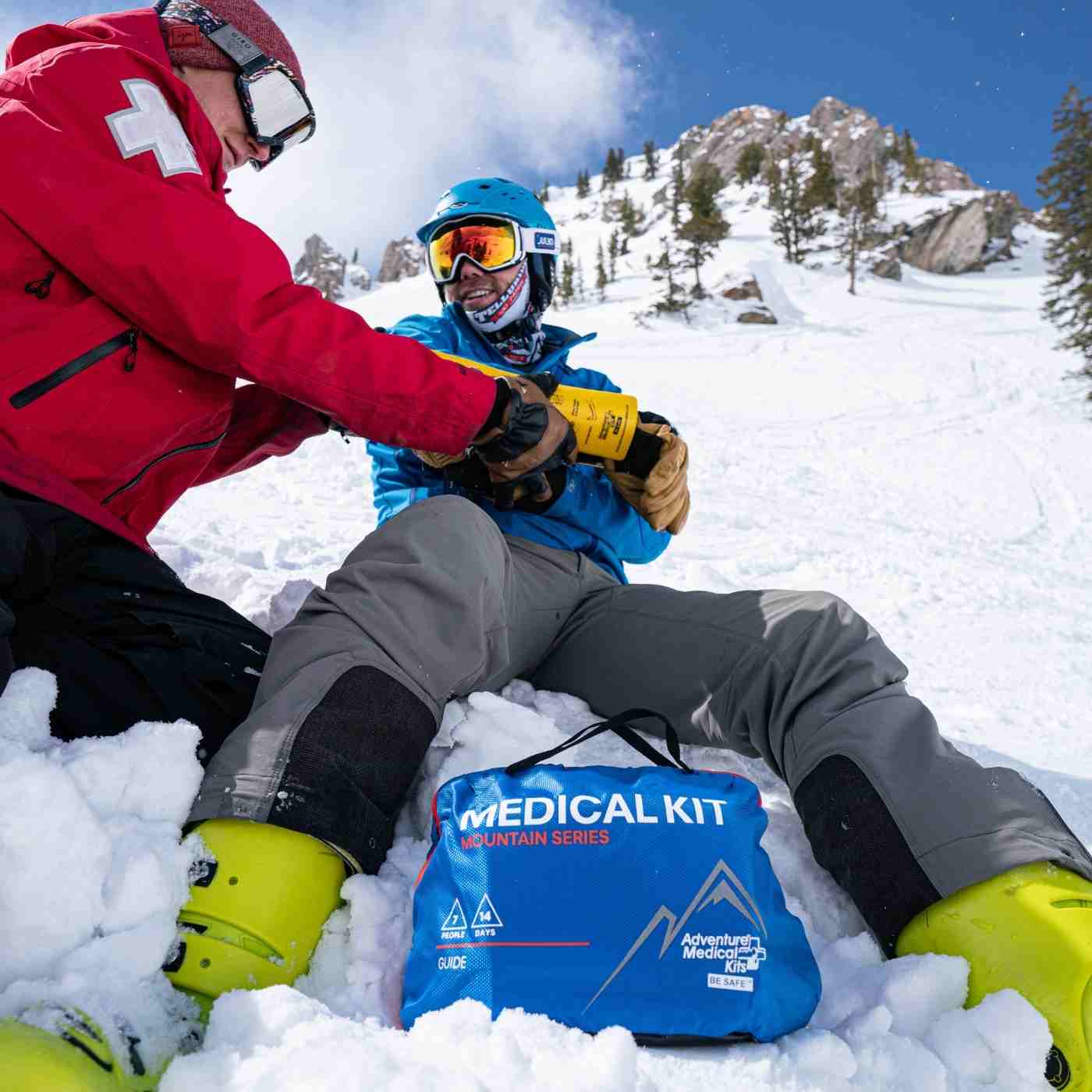Mountain Series Medical Kit - Guide Ski Patrol tending to broken arm with kit in front on snow