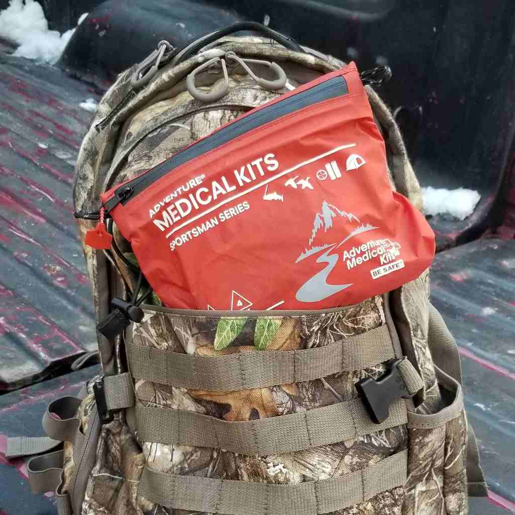 Sportsman Series Medical Kit - 100 kit sitting in camo backpack in truck bed