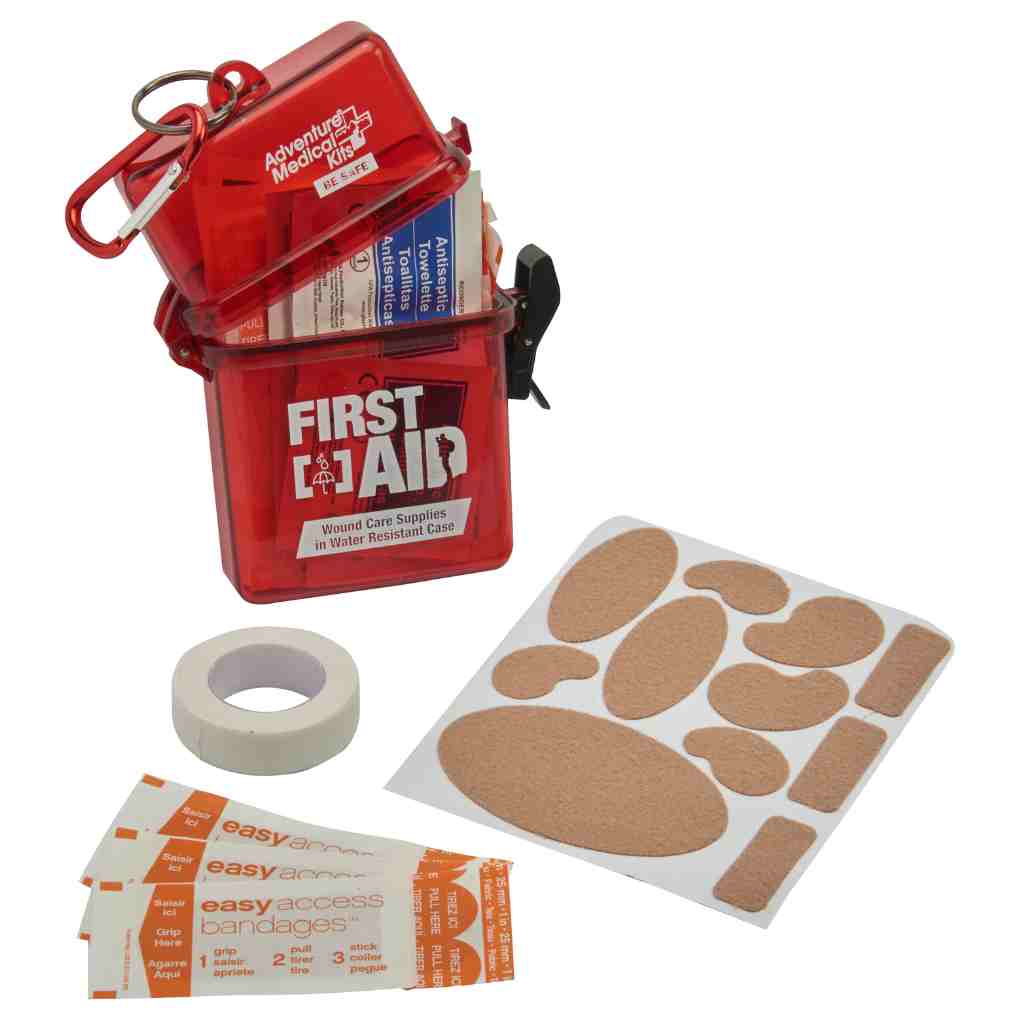 Adventure First Aid, Water-Resistant Kit kit opened with some contents around it