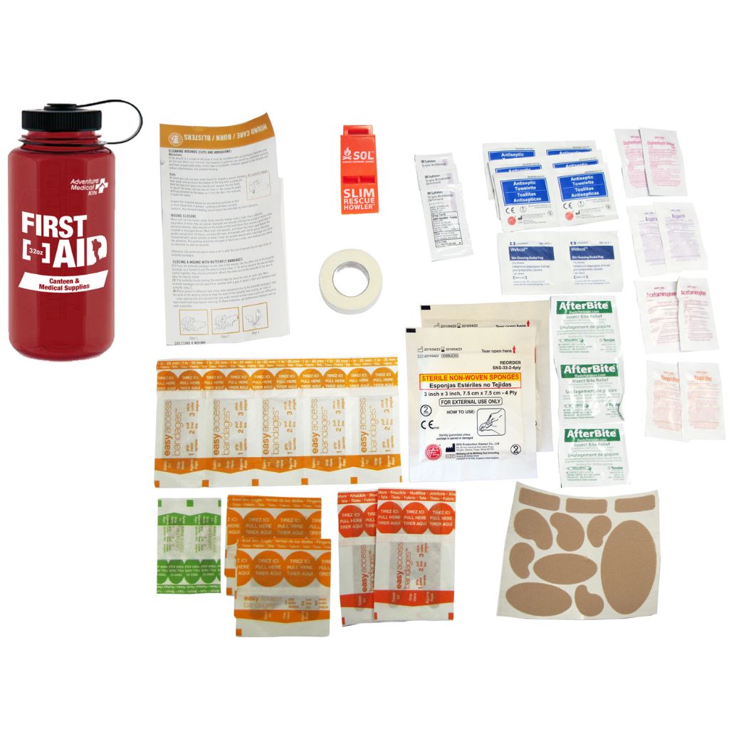 A comprehensive first aid kit laid out on a white background, featuring a red insulated water bottle, instruction sheets, adhesive bandages, antiseptic wipes, pain relievers, and other medical supplies.