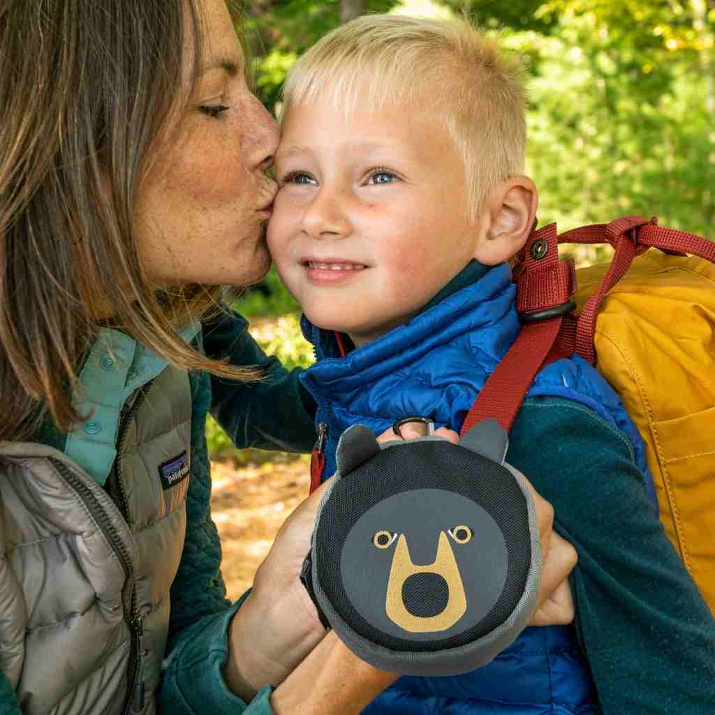 Backyard Adventure Bear First Aid Kit mom kissing child's cheek while holding kit
