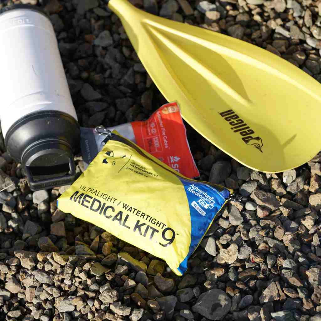 Ultralight/Watertight Medical Kit - .9 kit posed next to paddle and water bottle
