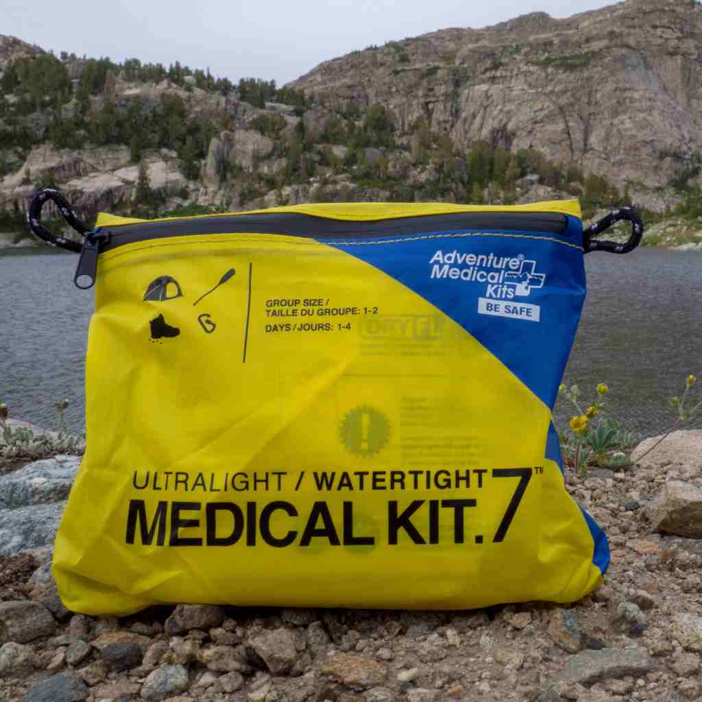 Ultralight/Watertight Medical Kit - .7 kit posed in front of lake