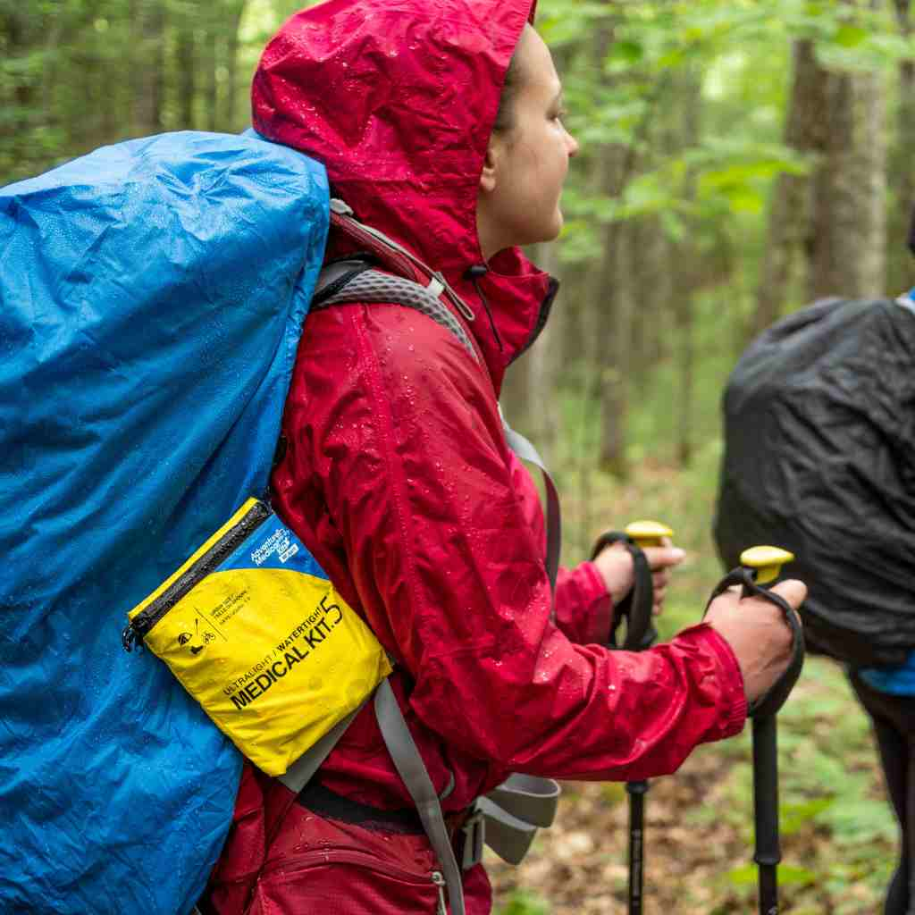 Ultralight/Watertight Medical Kit - .5 on hiker's back while hiking in the rain