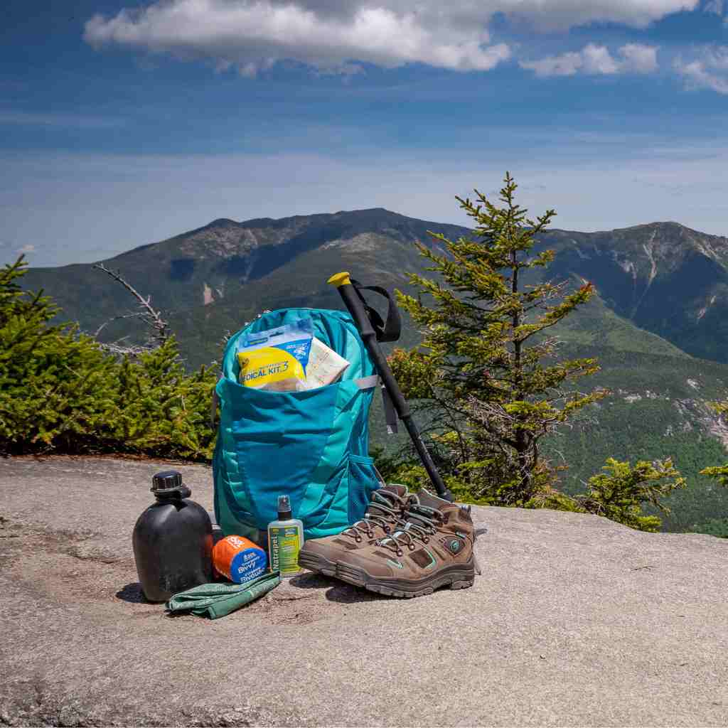 Ultralight/Watertight Medical Kit - .3 kit with hiking gear posed on rock in front of mountains