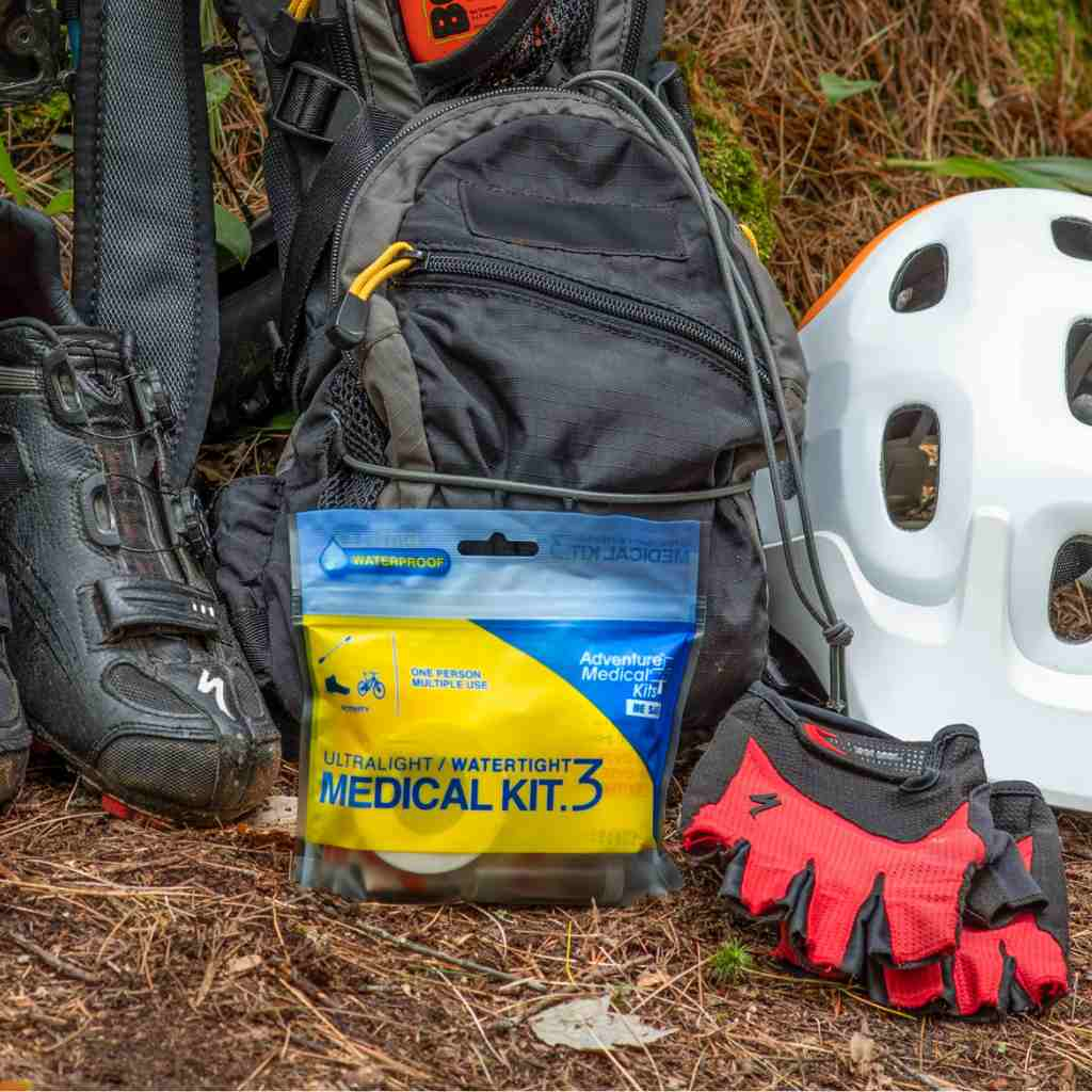 Ultralight/Watertight Medical Kit - .3 kit posed in front of biking gear