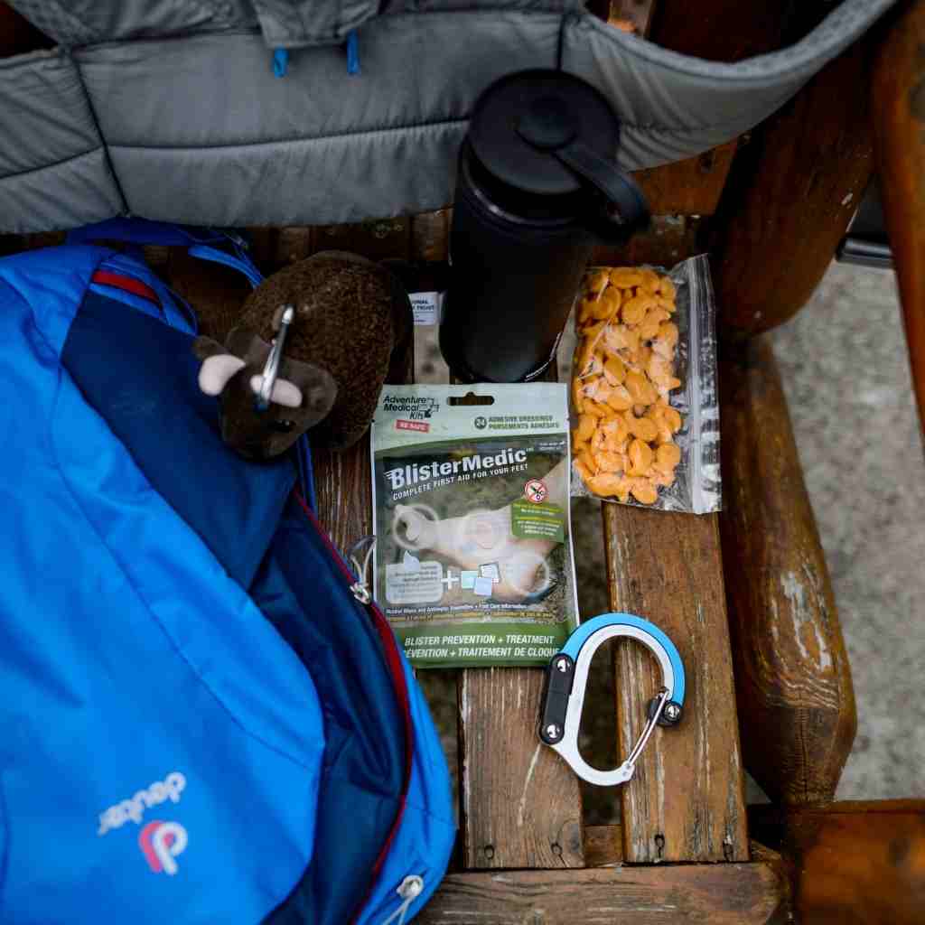 Blister Medic Kit next to bag of snacks and carabiner