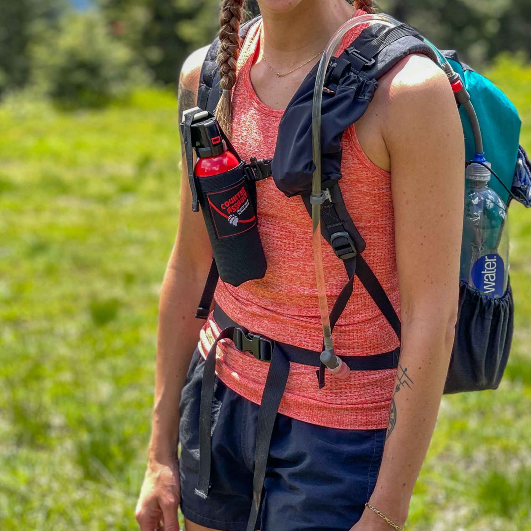 Woman with a Counter Assault bear deterrent attached to her bag