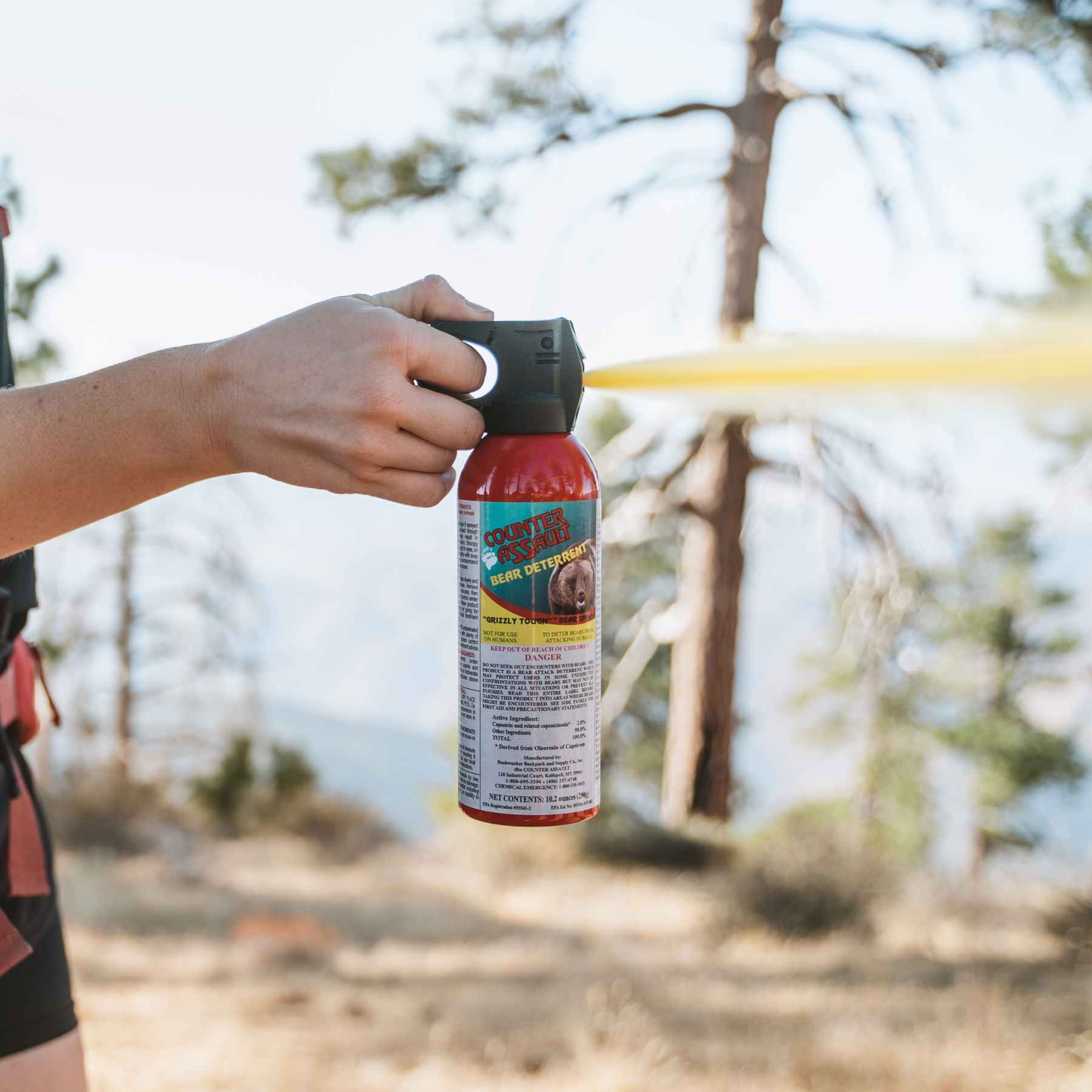 Woman spraying with Counter Assault bear deterrent spray