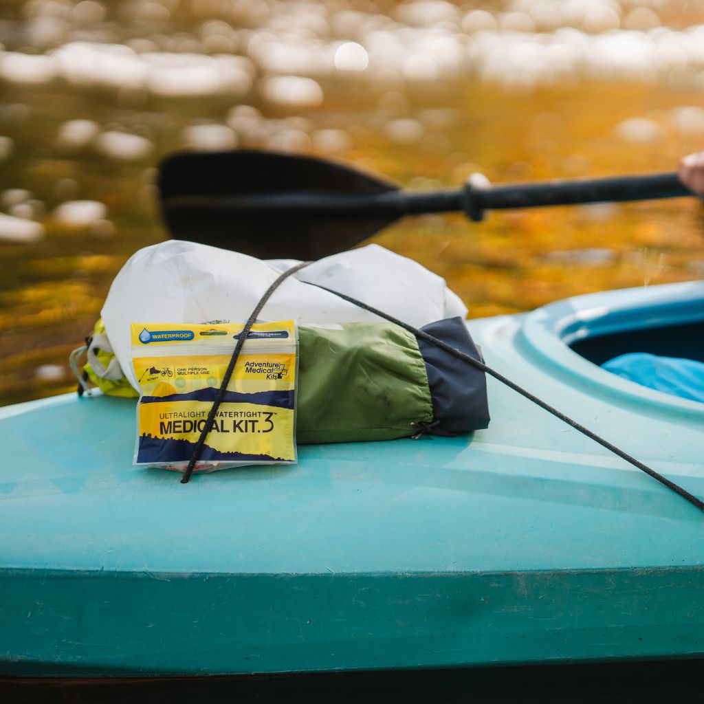 Medical kit on a kayak with a blurred water background