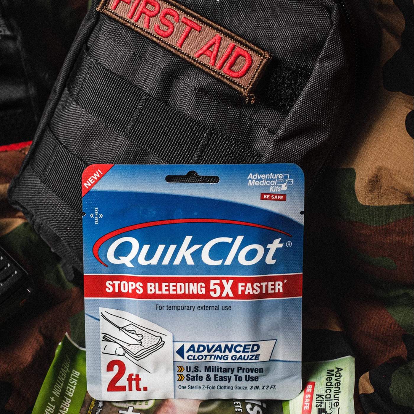 QuikClot on black MOLLE kit with First Aid patch