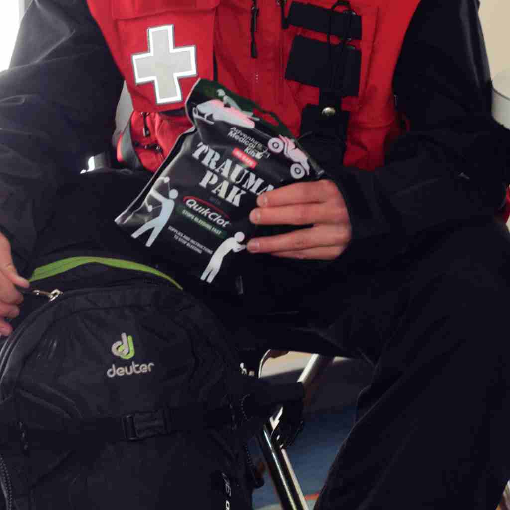 Trauma Pak First Aid Kit with QuikClot Ski Patrol removing kit from backpack