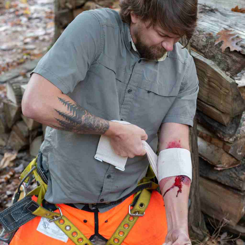 Trauma Pak First Aid Kit with QuikClot man using gauze on bleeding arm