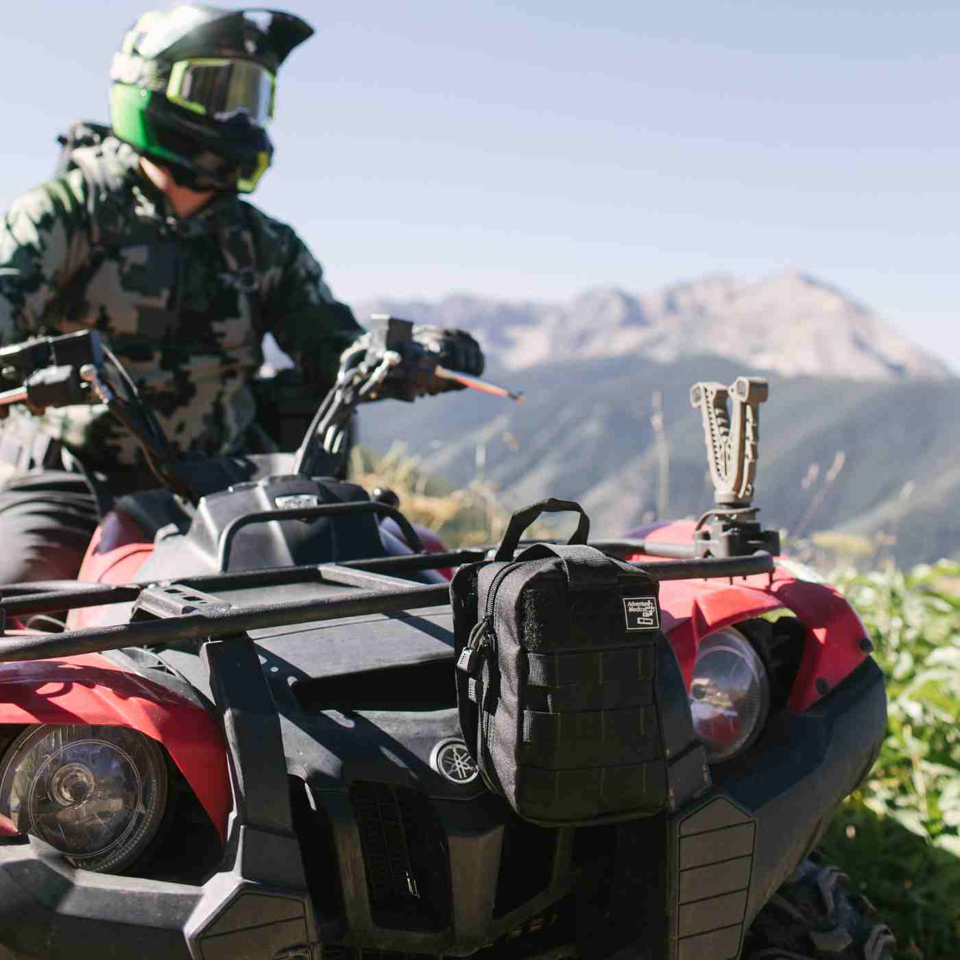 MOLLE Bag Trauma Kit 2.0 - Black kit on front of ATV with person in helmet and camo riding it